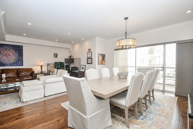 dining space with hardwood / wood-style flooring, crown molding, plenty of natural light, and a notable chandelier