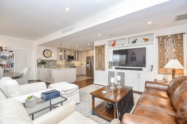 living room featuring light hardwood / wood-style floors and ornamental molding