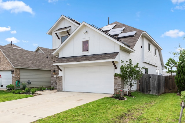 view of front of property with solar panels, a garage, and a front yard