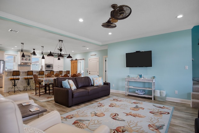 living room featuring crown molding and hardwood / wood-style floors