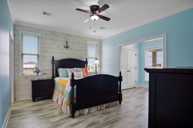 bedroom with ceiling fan, light hardwood / wood-style flooring, and crown molding