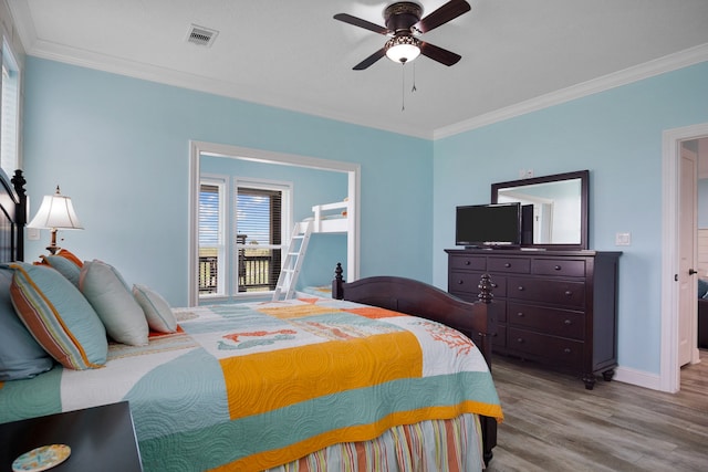 bedroom featuring ceiling fan, hardwood / wood-style flooring, and crown molding