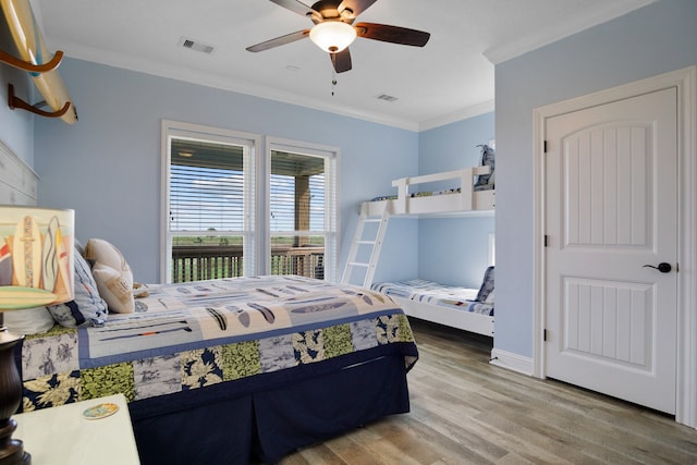 bedroom featuring crown molding, hardwood / wood-style flooring, and ceiling fan