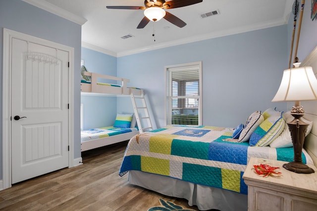 bedroom with ceiling fan, ornamental molding, and hardwood / wood-style flooring