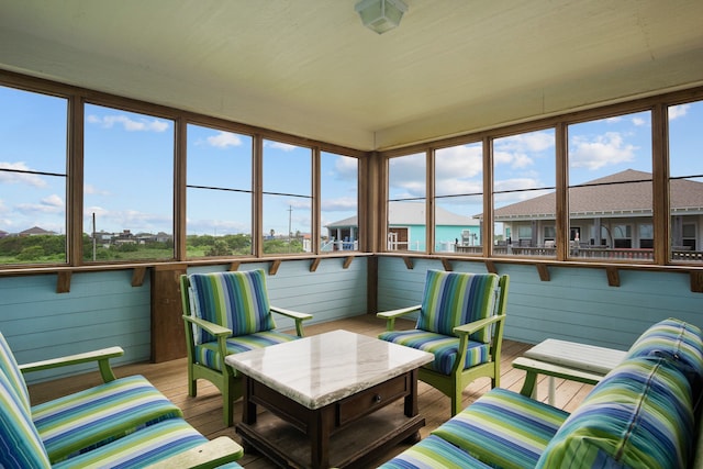 sunroom / solarium featuring a wealth of natural light and a water view