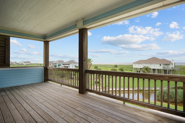 wooden terrace featuring a lawn