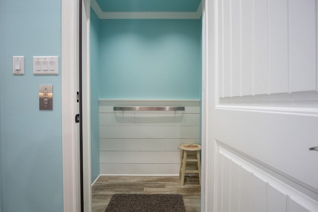 bathroom featuring ornamental molding and hardwood / wood-style floors