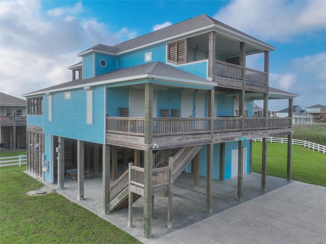 rear view of house with a yard and a patio