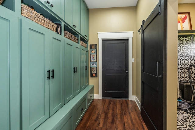 mudroom with dark hardwood / wood-style flooring and a barn door