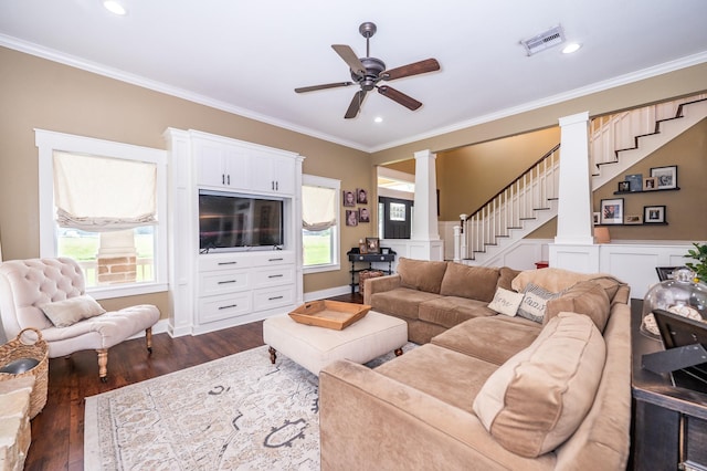 living room featuring ornate columns, dark hardwood / wood-style flooring, ceiling fan, and ornamental molding