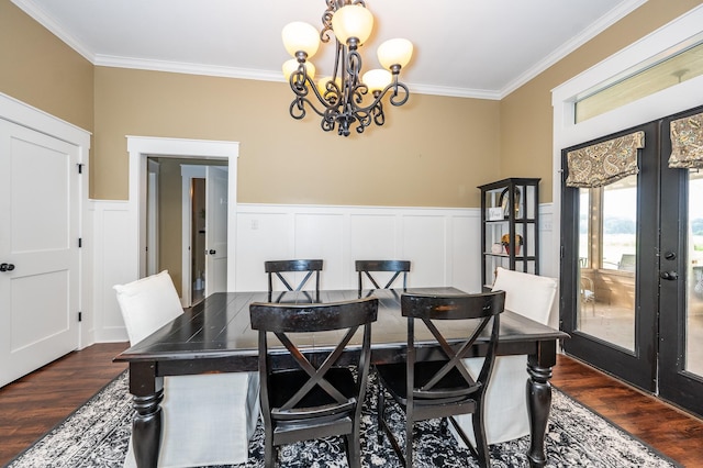 dining room with ornamental molding, dark hardwood / wood-style flooring, french doors, and a notable chandelier