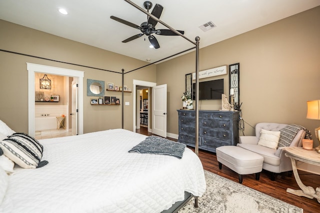 bedroom with connected bathroom, hardwood / wood-style floors, and ceiling fan