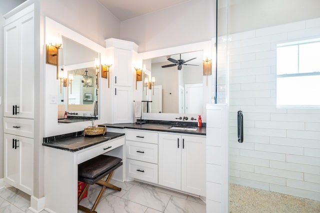 bathroom with ceiling fan, walk in shower, and vanity