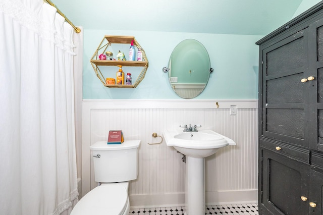 bathroom featuring sink, tile patterned flooring, and toilet