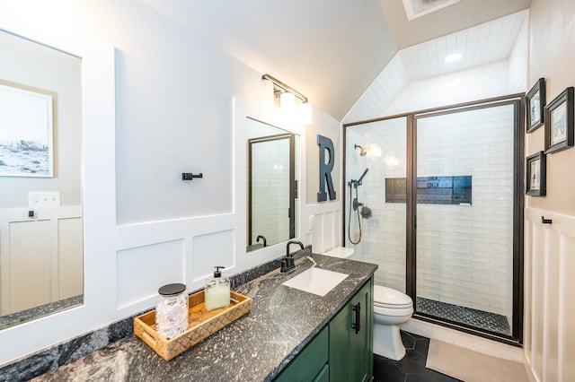 bathroom with toilet, tile patterned flooring, walk in shower, and vanity