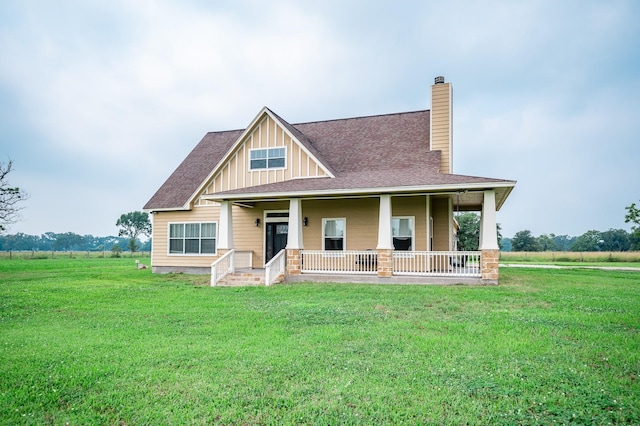 view of front of home with a porch and a front lawn