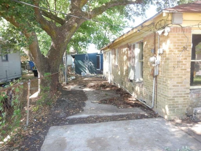 6636 Ave P, Houston, TX 77011 - view of side of home with brick siding and a patio
