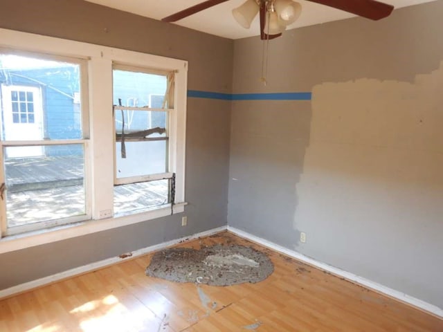 spare room with hardwood / wood-style floors and ceiling fan