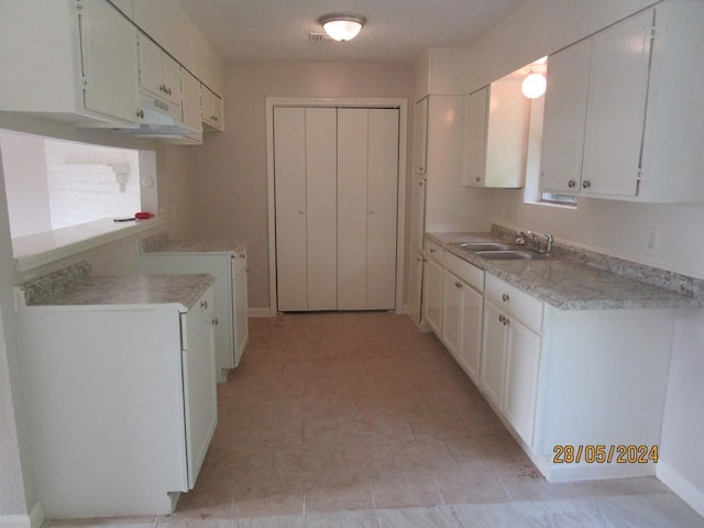 12515 Cooperstown Dr, Houston, TX 77089 - kitchen featuring a sink, white cabinetry, and light countertops