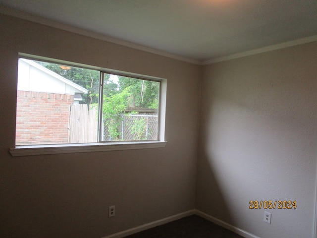 unfurnished room featuring crown molding