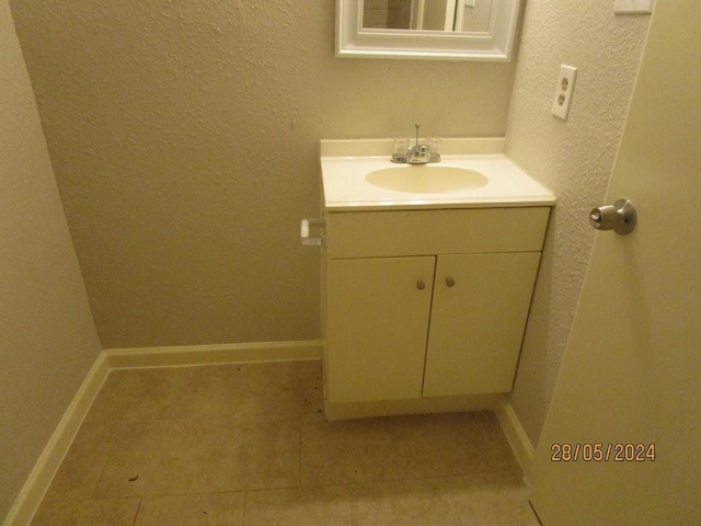 12515 Cooperstown Dr, Houston, TX 77089 - bathroom featuring vanity, tile patterned flooring, a textured wall, and baseboards