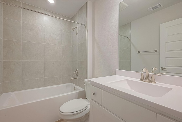 full bathroom with vanity, toilet, and tiled shower / bath combo