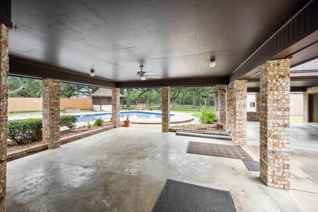 view of patio / terrace with a fenced in pool and ceiling fan