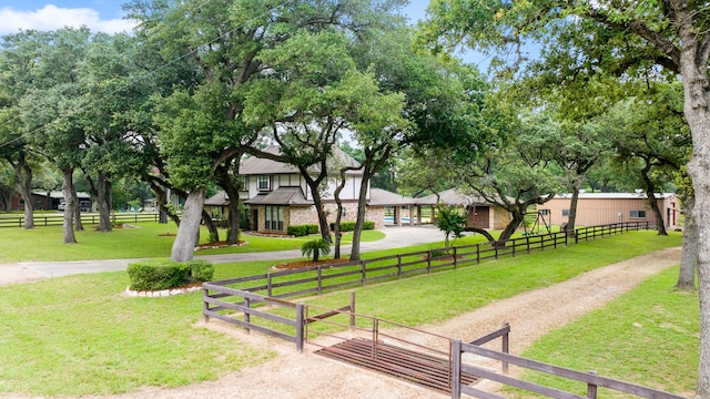 view of home's community featuring a lawn