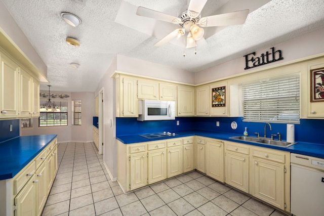 kitchen featuring light tile patterned flooring, sink, ceiling fan with notable chandelier, white appliances, and cream cabinets