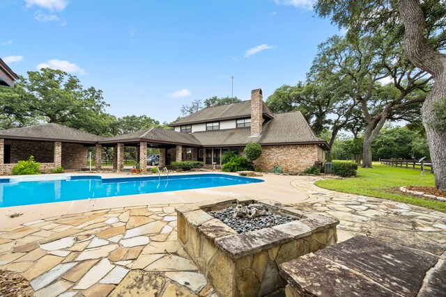 view of pool with a patio, a gazebo, and an outdoor fire pit