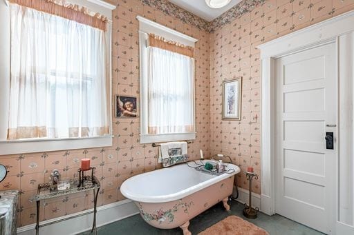 bathroom with a tub and plenty of natural light