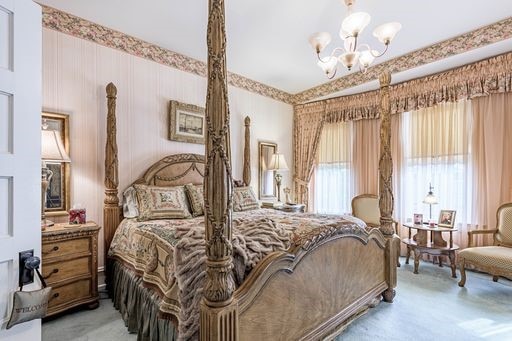 bedroom featuring carpet and a chandelier