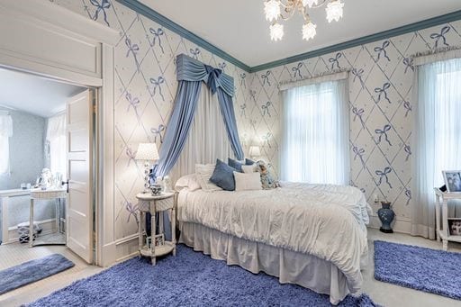 bedroom featuring carpet flooring, a chandelier, and multiple windows