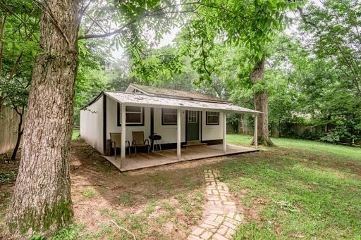 rear view of property featuring a yard