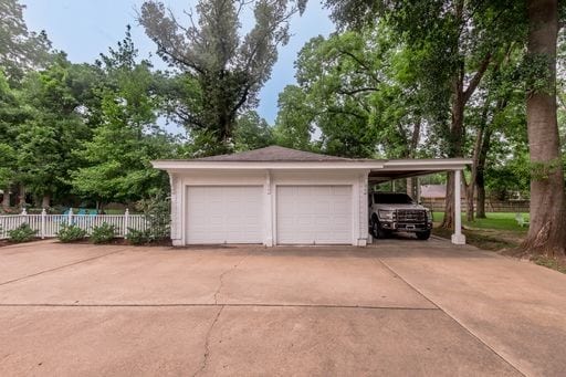 garage featuring a carport