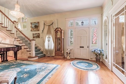 entryway featuring a chandelier, hardwood / wood-style flooring, and plenty of natural light