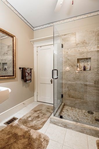 bathroom featuring tile floors, ornamental molding, walk in shower, and ceiling fan