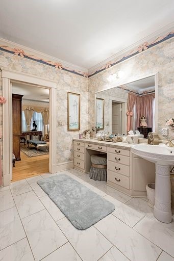 bathroom featuring ornamental molding and hardwood / wood-style floors