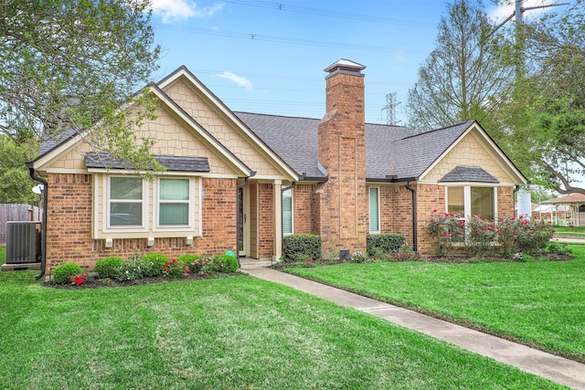 view of front of property with central AC and a front yard