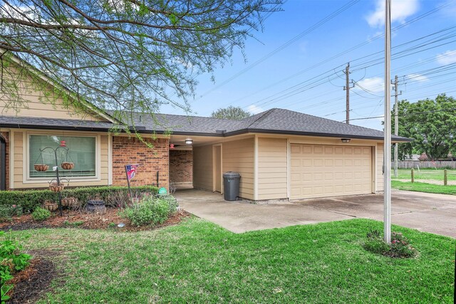 single story home featuring a garage and a front yard