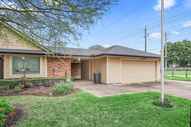 ranch-style house featuring a garage and a front lawn