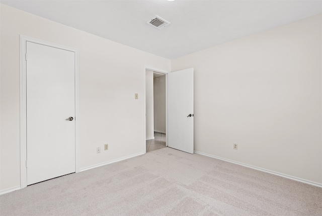 unfurnished bedroom featuring light carpet