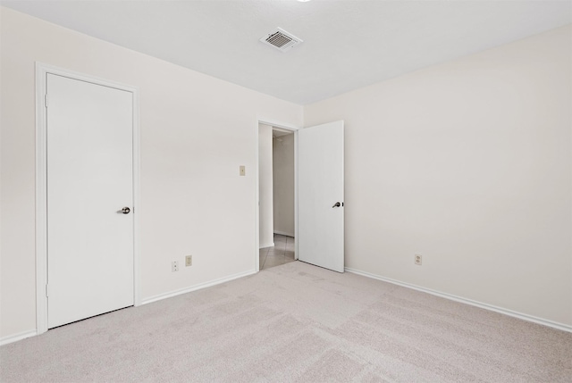 empty room featuring light carpet