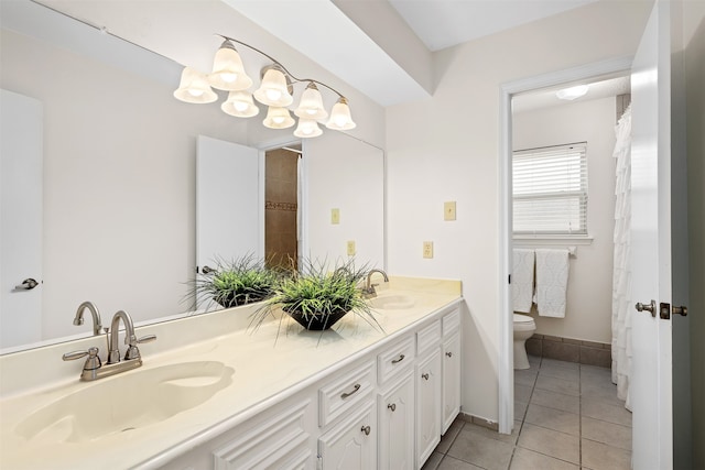 bathroom featuring dual vanity, tile patterned flooring, and toilet