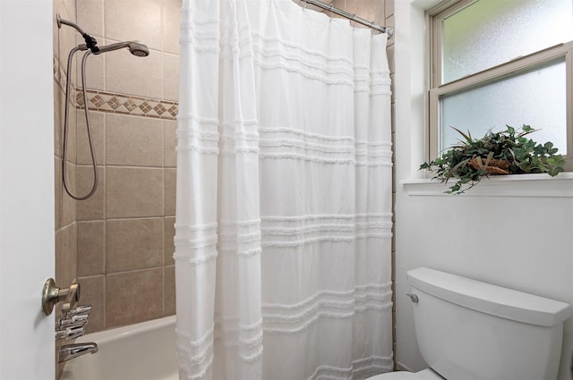 bathroom with shower / bathtub combination with curtain and toilet