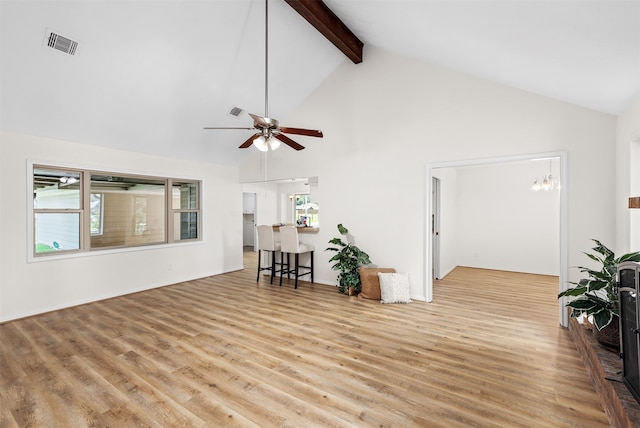 living room with high vaulted ceiling, beamed ceiling, light wood-type flooring, and ceiling fan