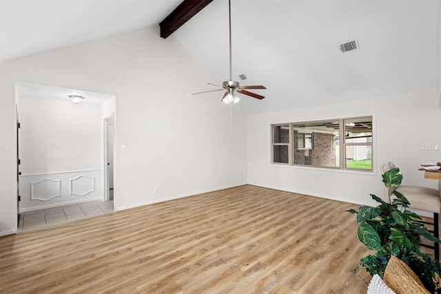 unfurnished living room with ceiling fan, beam ceiling, high vaulted ceiling, and light hardwood / wood-style flooring