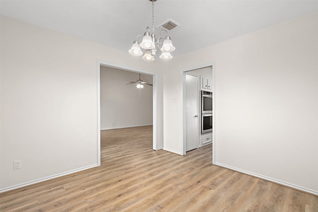 unfurnished dining area featuring light wood-type flooring and ceiling fan with notable chandelier