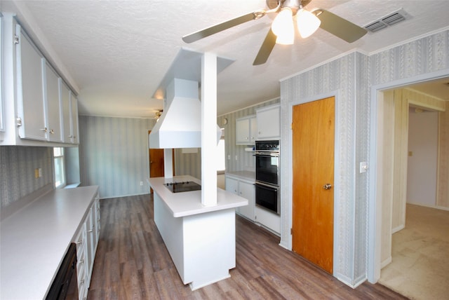 kitchen featuring visible vents, dark wood-style floors, black appliances, and wallpapered walls