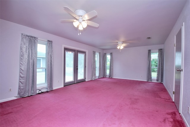 carpeted spare room with visible vents, a ceiling fan, baseboards, and french doors